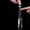 A hand is holding a premium stainless steel BBQ tongs against a black background.