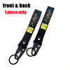 Front and back view of a black JDM style anime girl keychain with a steel clip.