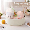 A light beige handwoven rope storage basket filled with soft, fluffy baby toys for children.