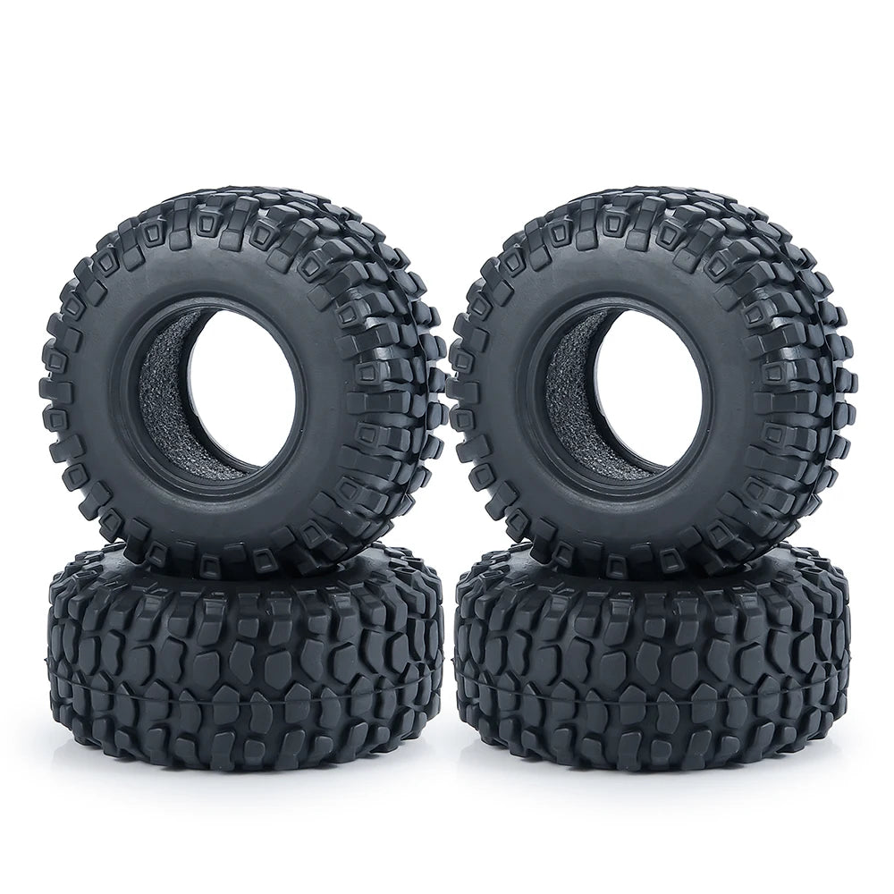 A pair of black rubber mud terrain tires stacked on top of each other.