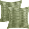 A set of two olive green corduroy throw pillow covers with a vertical ribbed texture.