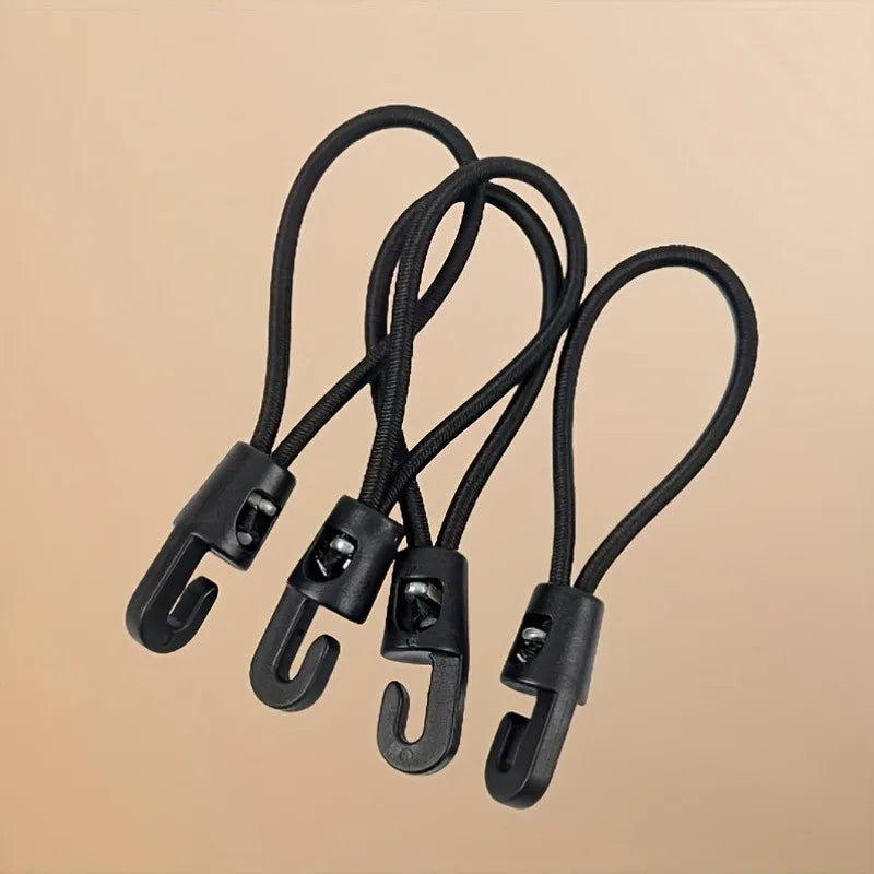 Black heavy-duty elastic tie-down straps with metal hooks displayed against a beige background.
