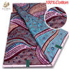 A close-up view of 100% cotton African wax print fabric featuring intricate purple, pink, and teal swirling patterns.