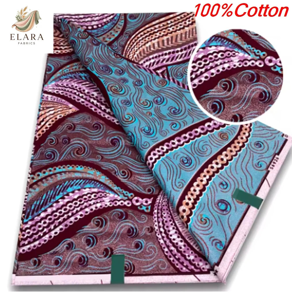 A close-up view of 100% cotton African wax print fabric featuring intricate purple, pink, and teal swirling patterns.