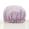 A lavender reusable elastic shower cap with gold heart pattern.