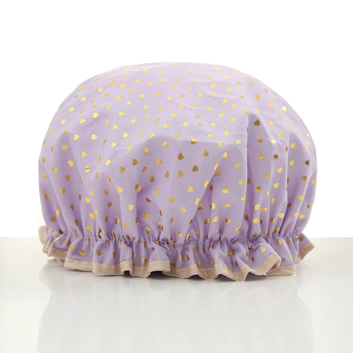 A lavender reusable elastic shower cap with gold heart pattern.