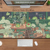 A large desk mat featuring a kawaii nature design of various frogs and plants.