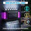 An RGB solar wall light mounted on a stone surface, featuring a solar panel and colorful illumination.