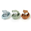 Three silicone animal finger puppets in gray, green, and brown sitting in small bowls for toddlers