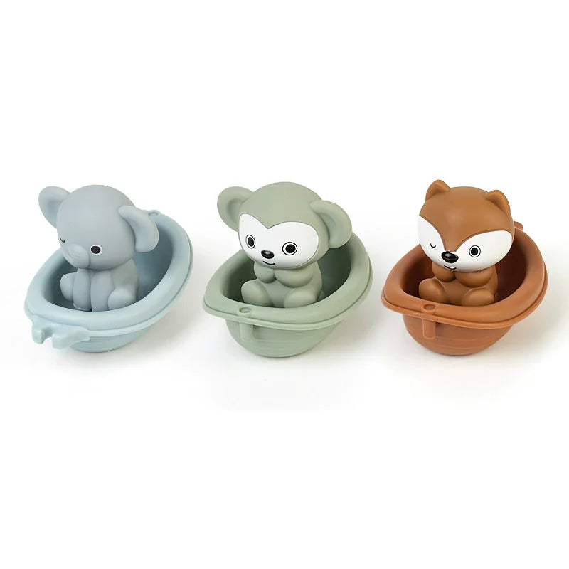 Three silicone animal finger puppets in gray, green, and brown sitting in small bowls for toddlers