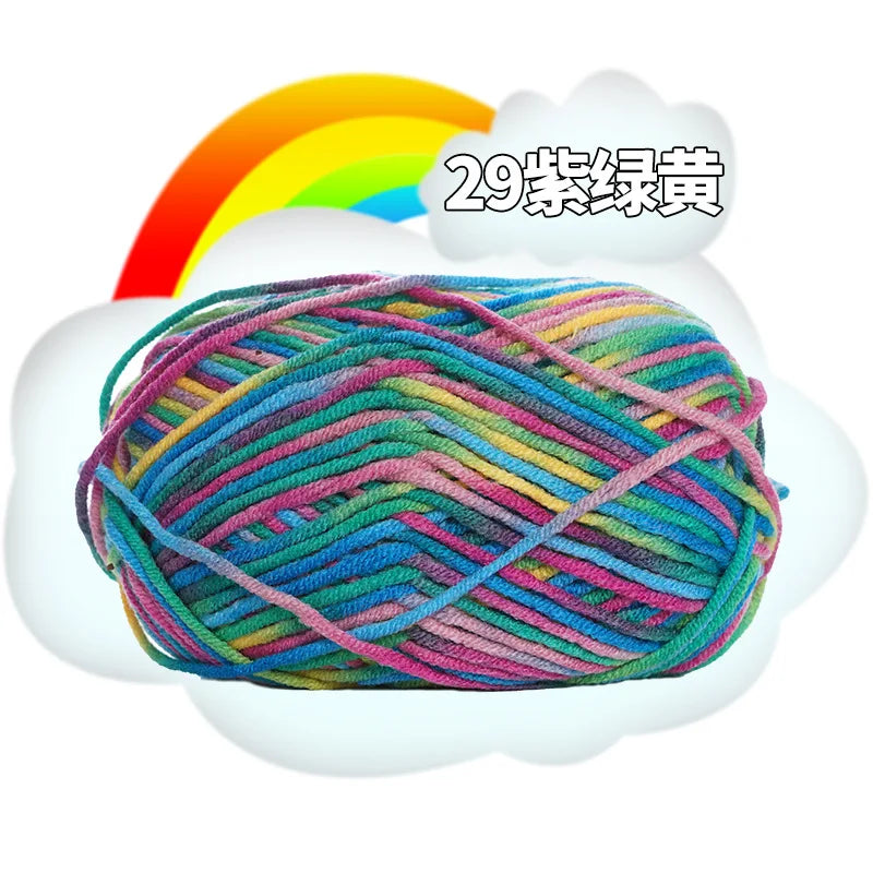 A ball of multi-colored milk cotton blend yarn with a rainbow graphic above it.