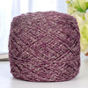 A ball of metallic purple silk crochet yarn with silver shimmer thread for knitting and macrame.