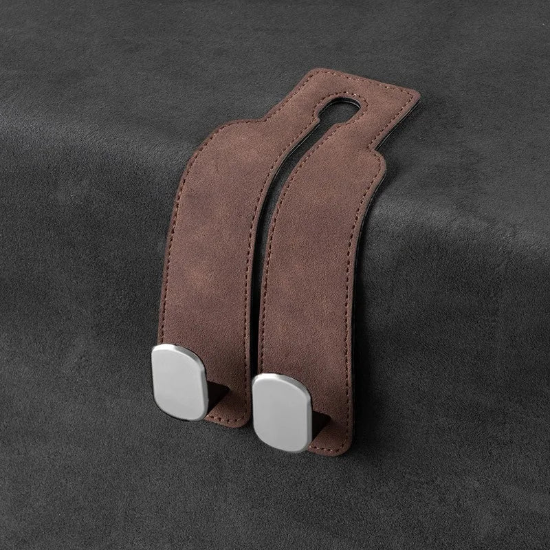 Dual suede hooks for handbags and other items, designed for car seat back storage.