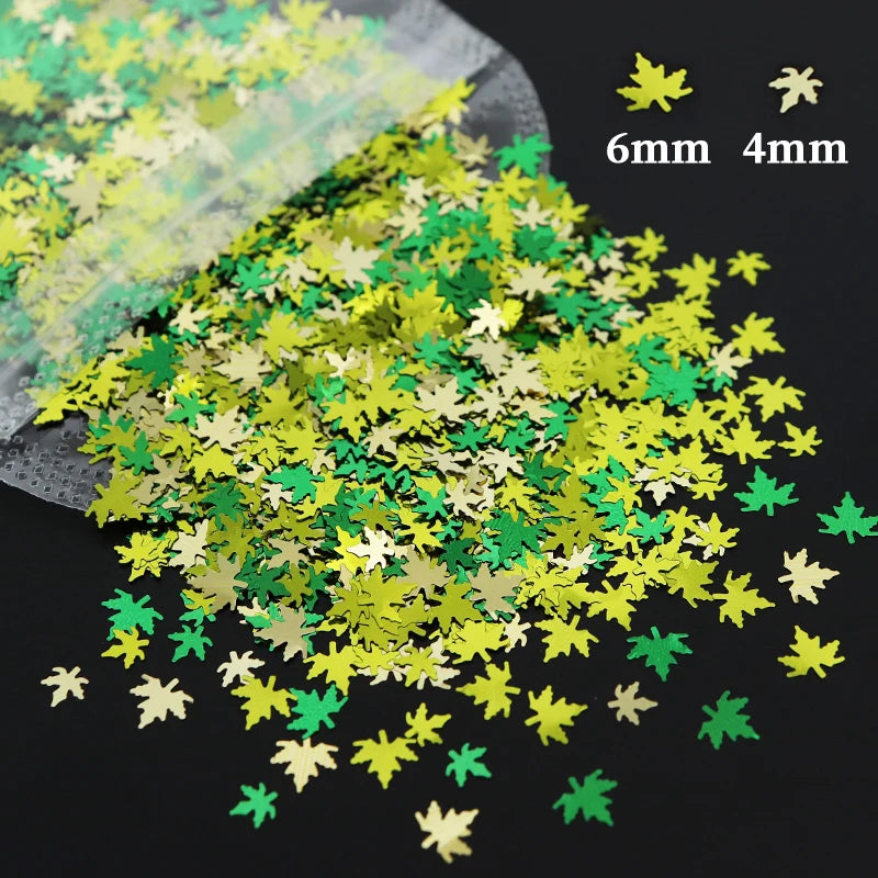 A pile of shiny holographic star sequins in gold and green colors, showing different sizes.