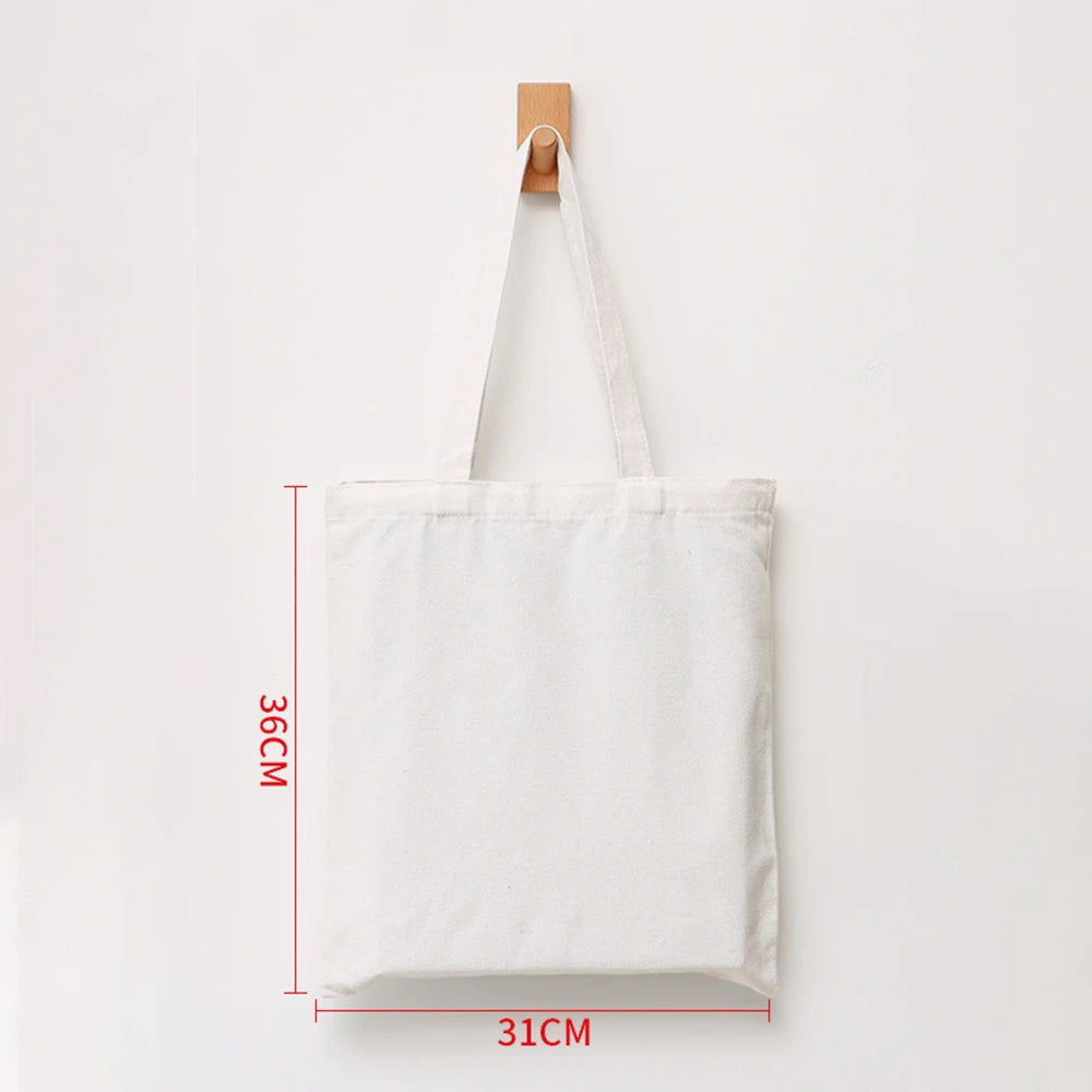 A white canvas shopping tote bag with a wooden handle, shown against a white background.