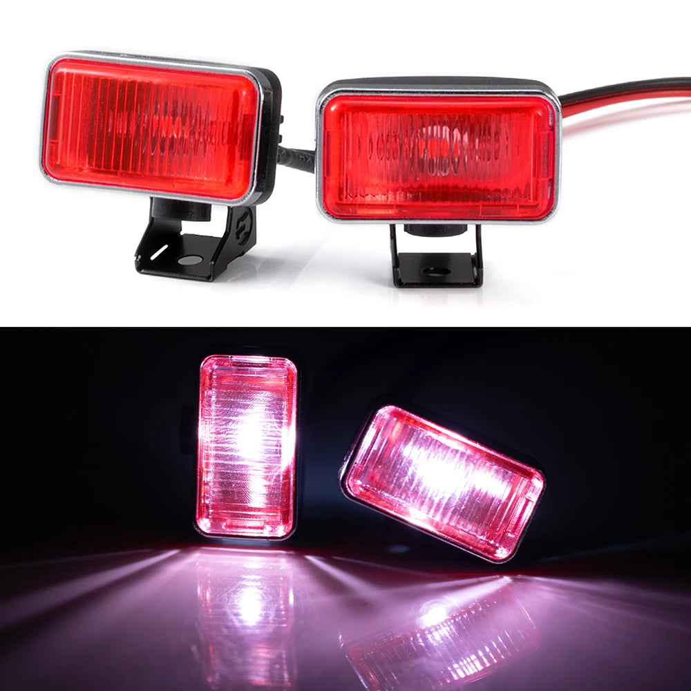 A pair of red LED headlights and spotlights for an RC crawler truck.