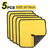 Five yellow microfiber cleaning towels with black edges shown stacked.