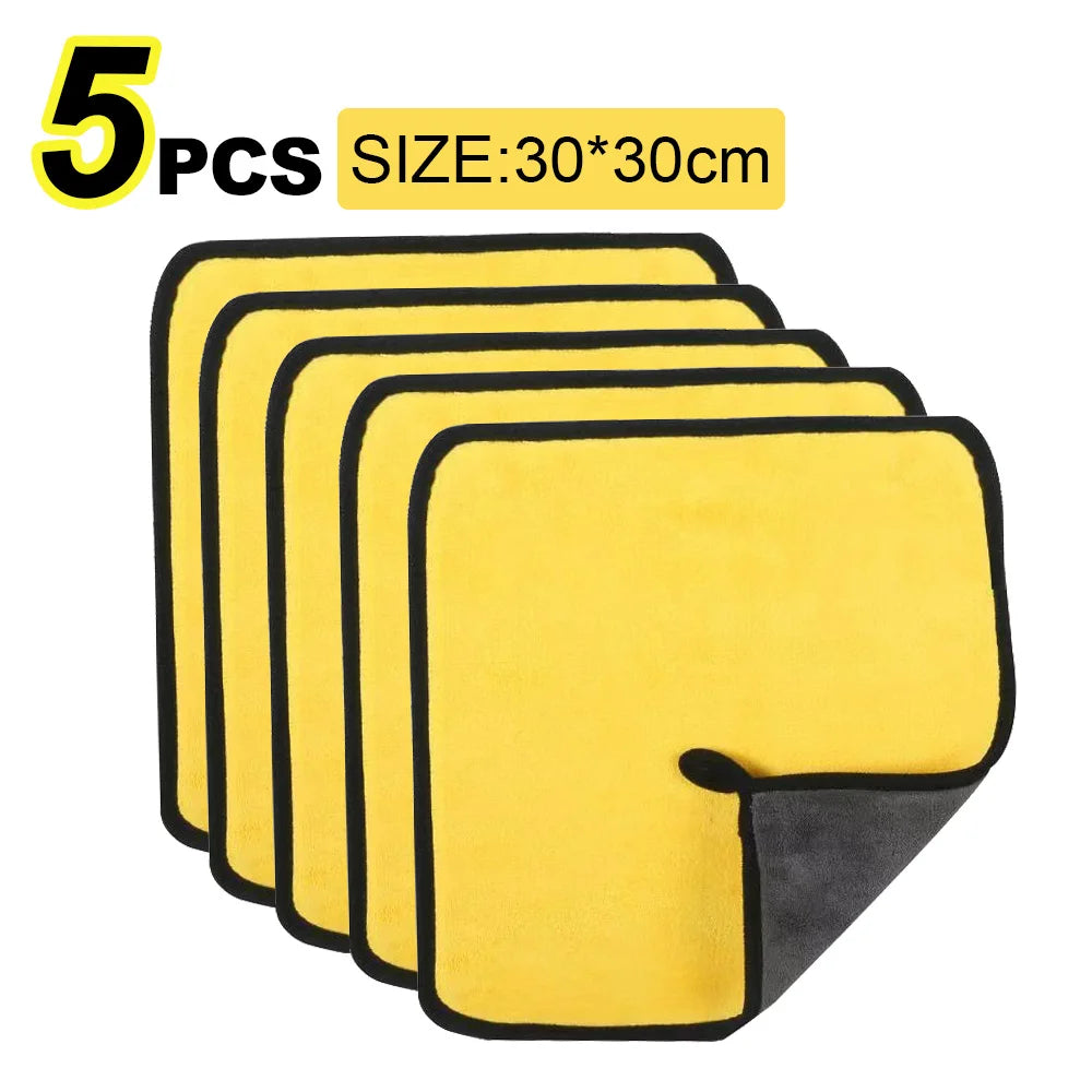 Five yellow microfiber cleaning towels with black edges shown stacked.