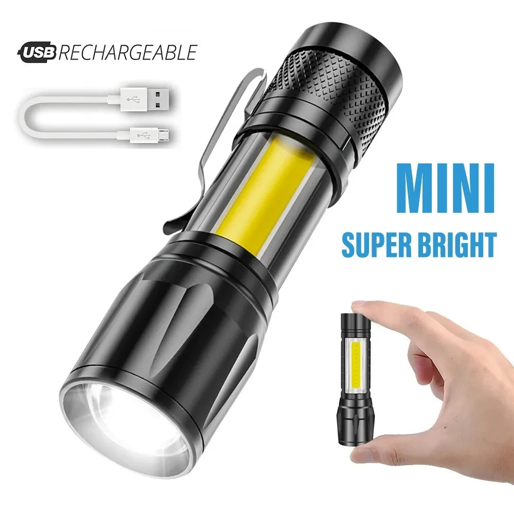 A black rechargeable mini super bright LED flashlight with a yellow light, shown next to a hand.