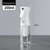 A clear, transparent mist spray bottle with a white pump dispenser and a cylindrical glass body is shown against a gray backg