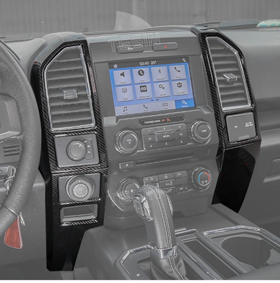 Carbon fiber grain center console trim cover for a Ford F-150 showing the interior dashboard and controls.