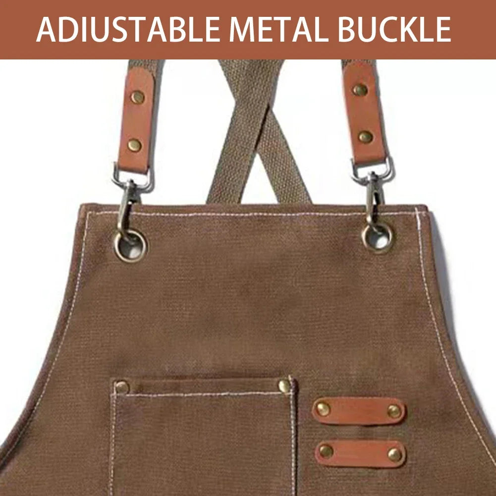 A brown canvas apron featuring an adjustable metal buckle strap and a large front pocket.