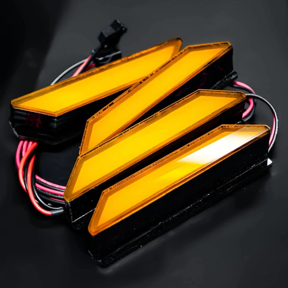 Three amber LED grille lights for a Ford Ranger Raptor, shown against a dark background.