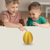 Two young boys pointing at a golden Easter egg desk decor item.