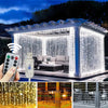 LED curtain string lights with remote control fairy lights illuminating a modern outdoor structure and various decorative set