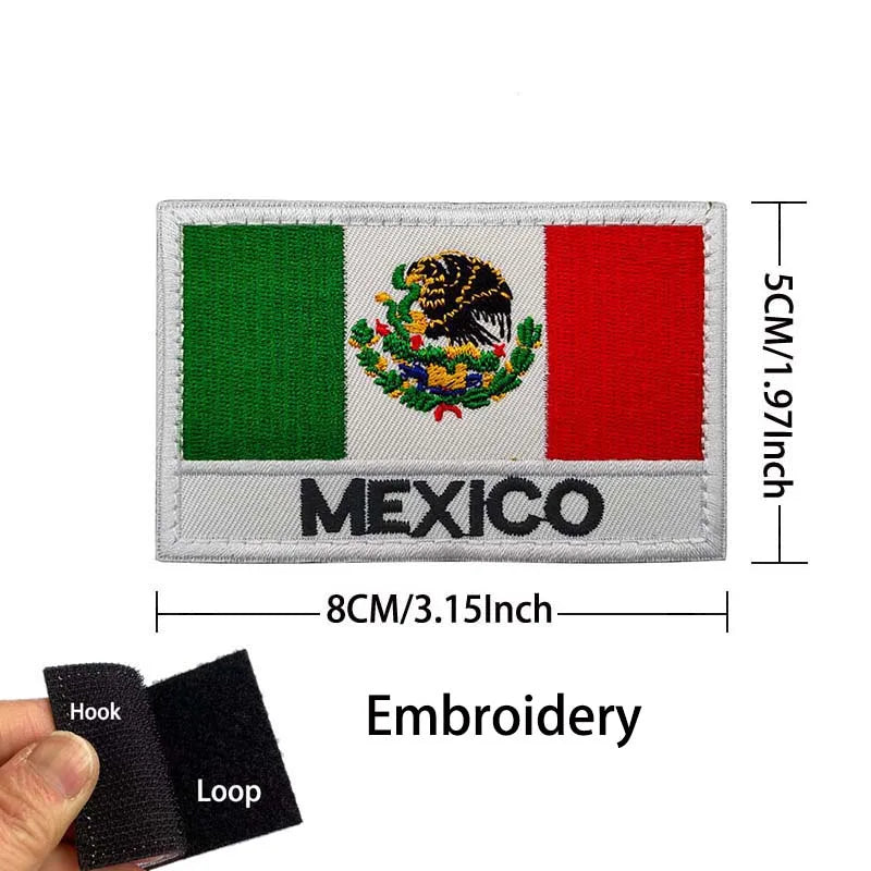 A rectangular embroidered patch featuring the Mexican flag, an eagle skull emblem, and the word MEXICO on a gray fabric with 