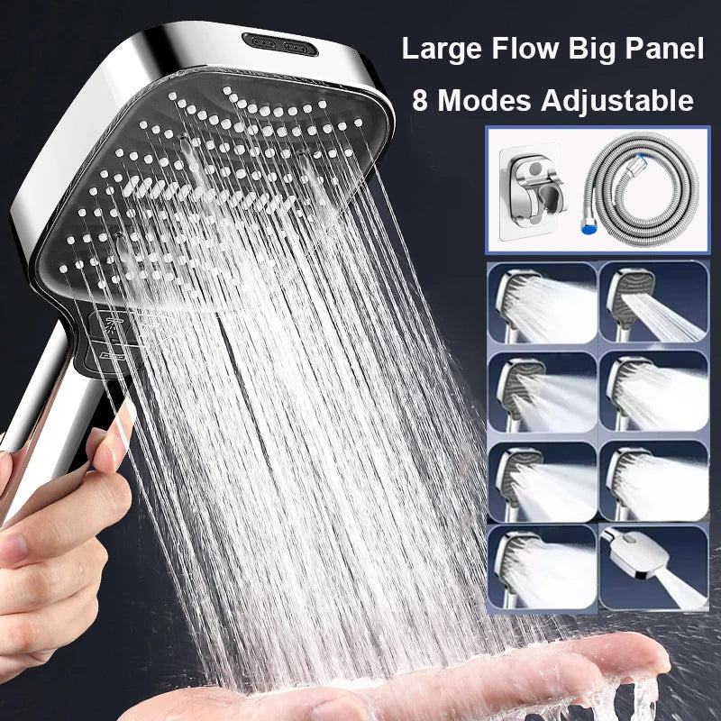 A hand is holding a large flow big panel shower head spraying water onto a palm.
