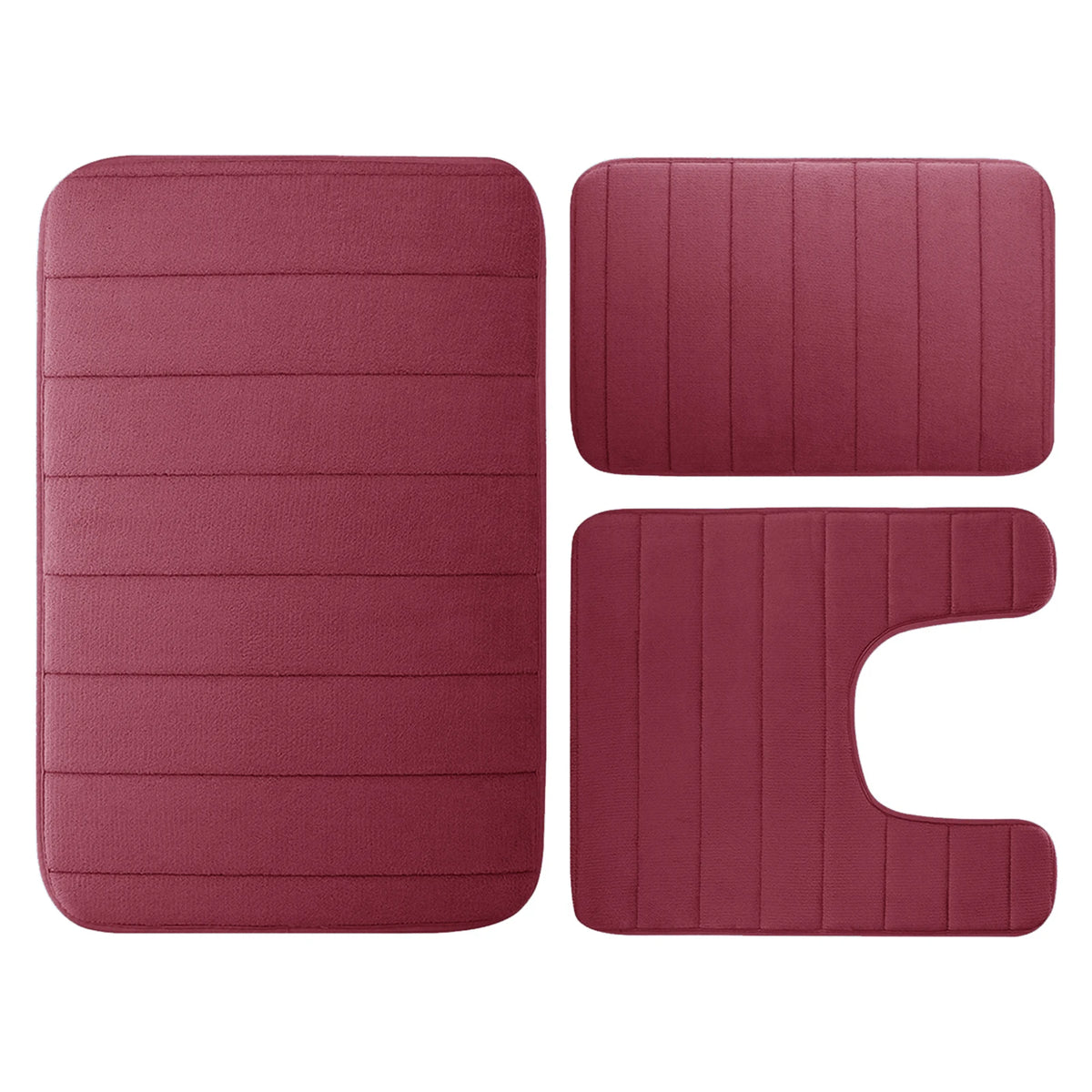 A set of three rectangular plush memory foam bath mats in a dusty rose color.