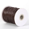 A spool of dark brown waxed cord rope for jewelry making and DIY projects.