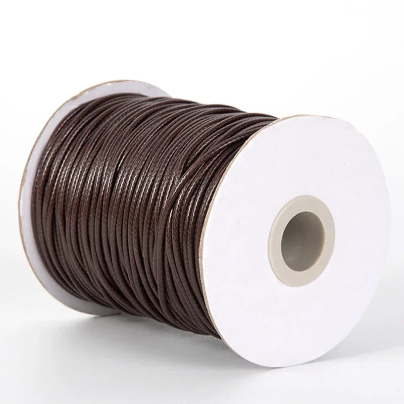 A spool of dark brown waxed cord rope for jewelry making and DIY projects.