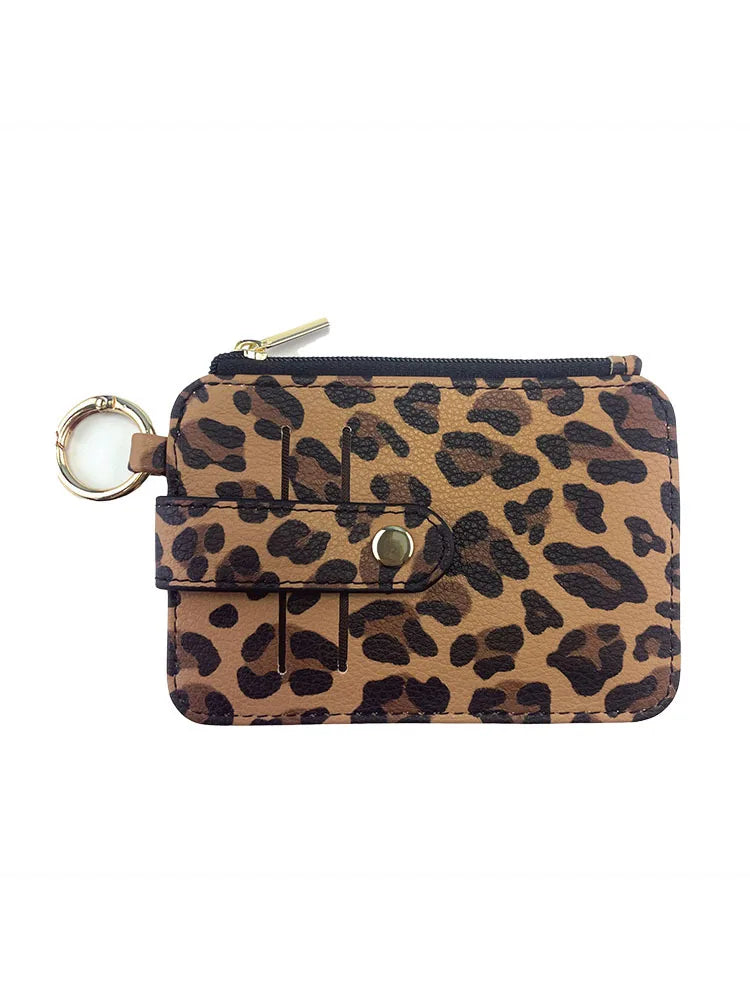 A brown leopard print PU leather card holder with a coin pocket and attached keychain.