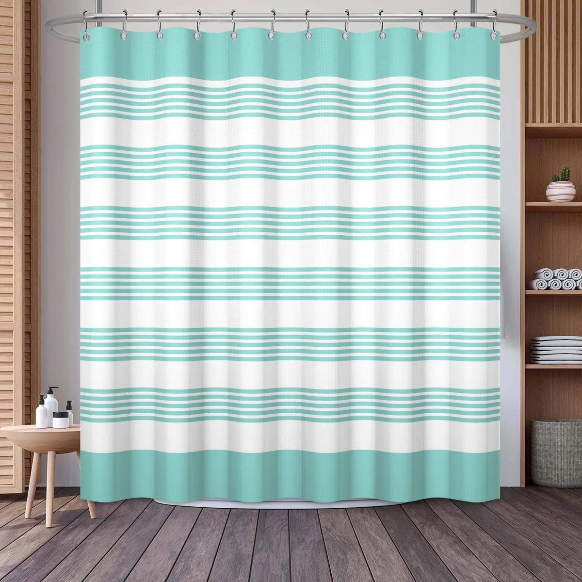 A light mint green and white striped waffle weave shower curtain hanging from a metal rod.