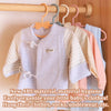 A set of baby clothes hangers displaying various light-colored and striped garments for organization.
