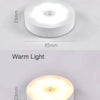 A comparison of a white light and a warm light version of a round LED night light, both measuring 85mm in diameter and 23mm t