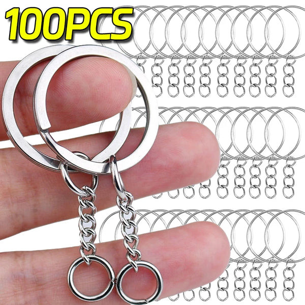 A hand holds a set of 100 stainless steel keychain rings and chains.