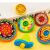 Colorful five-layer stacking spinning top toys in various bright colors on a yellow background.