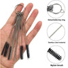 A hand holds a detachable key ring with multiple stainless steel jet needles and a nylon brush for carburetor cleaning.