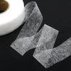 Roll of clear double-sided iron-on adhesive tape for fabric hemming and repairs