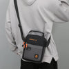 A gray hoodie is shown holding a black and gray crossbody bag with an adjustable strap.