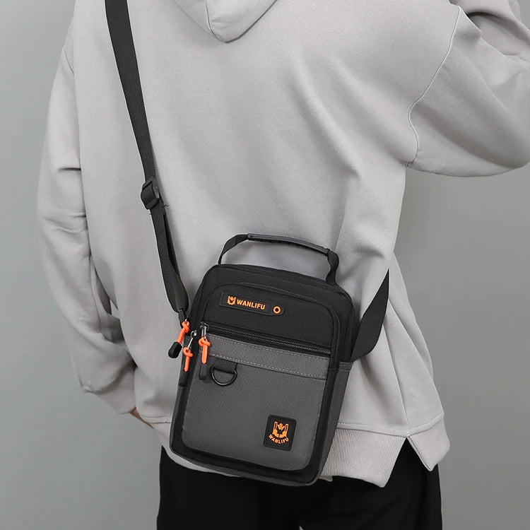 A gray hoodie is shown holding a black and gray crossbody bag with an adjustable strap.