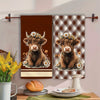 A set of two Highland cow plaid kitchen towels featuring a brown and tan pattern.