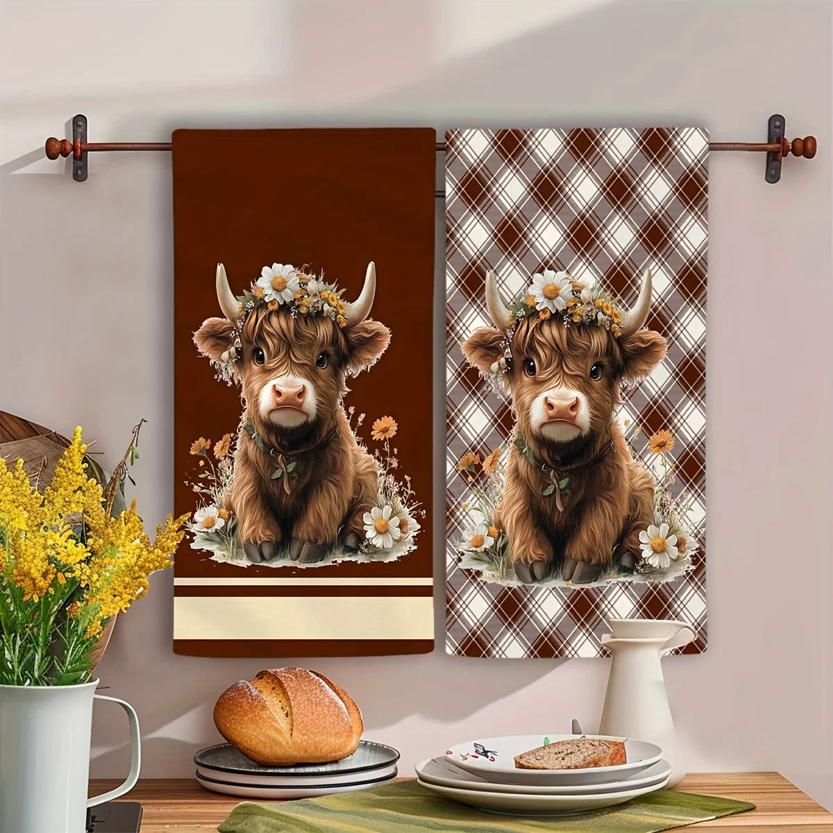 A set of two Highland cow plaid kitchen towels featuring a brown and tan pattern.
