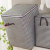 A quilted storage bag with a black and white houndstooth pattern is shown next to an open version.