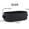 A dark gray woven cotton rope storage basket with leather handles shown flat.