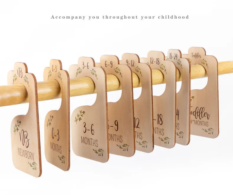 A wooden baby closet divider set with eight size organizers for newborns through 24 months.