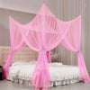 Pink sheer mosquito net draped over a bed for protection